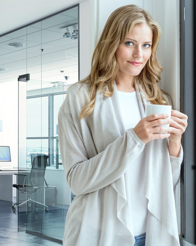 Woman having a coffee break in a corporate office